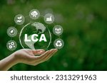 LCA, Life cycle assessment concept in hand. ISO LCA standard aims to limit climate change. Methodology for assessing environmental impacts associated on value chain product.