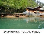 Small photo of 3 April 2018 Hunan Fenghuang (Phoenix) Ancient Town, China : boats waiting for tourists to enjoy Tuojiang River in Fenghuang village which was added to the UNESCO World Heritage Tentative List