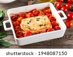 Small photo of Baked feta pasta. Feta cheese and tomatoes in garlic oil. In the oven it turns into an amazing pasta sauce by itself. Just add some cooked pasta, mix and enjoy. Tiktok pasta