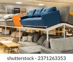 Furniture store with sofas and couches on display for sale, copy space. Showroom in the upholstered furniture store department with sofas and couches.