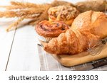 Butter Croissant with Sourdough and Danish Pastry on white wood background, Homemade bakery concept