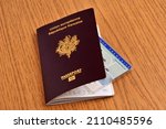 Small photo of Vannes, France, January 16, 2022 : French biometric passport with an identity card in it on a wooden table