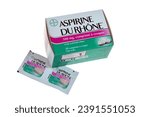 Small photo of Vannes, France, october 18, 2023 : Box and aspirin tablets in their Du Rhone brand packaging close-up on a bench background