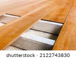 Small photo of Construction floor installation wooden work flooring wood plank. Timber flooring installation deck board. Repair floor covering. Repair house deck floor renovation home. Timber decking wood floorboard