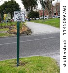 Small photo of Oakleigh, VIC / Australia - July 26 2018: Road sign for pedestrians and cyclists to watch for cars when crossing the road