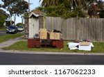 Small photo of Oakleigh, VIC / Australia - Aug 27 2018: cabinet and miscellaneous hard rubbish put on curbside for council annual collection