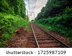 Railway track on a mountain and used sleepers. View from the railway stretch on the mountains and the jungle forest. Railway operational infrastructure. Electrified railroad route. 