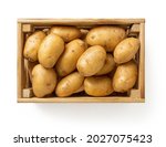 Raw yellow potatoes in a wooden ...