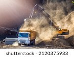 Small photo of Excavator and truck for construction site. Excavation is the process of moving earth, rock or other materials with tools, equipment or explosives. It includes earthwork, trenching, wall and tunneling.