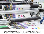 Small photo of Large offset printing press or magazine running a long roll off paper in production line of industrial printer machine.