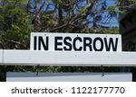 Small photo of Home in Escrow Sign