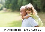 Little Child Girl Hugs Grandpa...