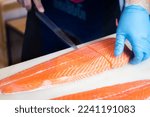 Small photo of Japanese chefs filleting salmon, a delicate professional skill to make the most of the fillets.