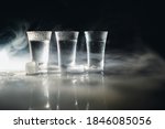 Vodka. Shots, glasses with vodka with ice .Dark background. Copy space .Selective focus