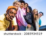 Small photo of Multicultural group of young friends bonding outdoors and having fun - Stylish cool teens gathering at urban skate park