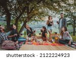 Small photo of Group of young happy friends having pic-nic outdoors - People having fun and celebrating while grilling ata barbacue party in a countryside
