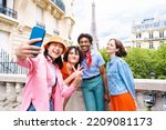 Small photo of Group of young happy friends visiting Paris and Eiffel Tower, Trocadero area and Seine river - Multicultural group of tourists sightseeing the France capital city