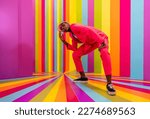 Beautiful african american young woman dancer having fun inside a rainbow box room - Cool and stylish black adult female portrait on colorful background, influencer creating content for social media