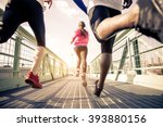 Three runners sprinting outdoors - Sportive people training in a urban area, healthy lifestyle and sport concepts