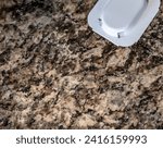 Small photo of Ant trap poison bate on a granite kitchen countertop