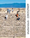 Small photo of Monte Alban, Oaxaca de Juarez, Mexico, 1st of January 2019, Tourists on the steps of mayan pyramid in Monte Alban