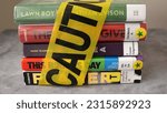 Small photo of Chicago, IL, USA - May 10 2023: A stack of books found on frequently banned book lists wrapped in caution tape