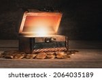 Small photo of old wooden chest with coins on the table, the chest is open, a bright light from the inside, the concept of a fairy tale, mystery, pirate treasure, wealth, pandora's box