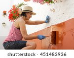 Mature Woman Painting The...