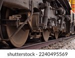 Small photo of Gillette, Wyoming - Janaury 23, 2021: Train wheels on a train engine on a railroad track in Gillette, Wyoming.