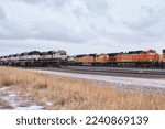 Small photo of Gillette, Wyoming - January 23, 2021: Three rows of train engines attached being stored on railroad tracks on a winter day near Gillette, Wyoming.