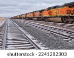 Small photo of Gillette, Wyoming - January 23, 2021: Railroad tracks with train engines on a cloudy winter day near Gillette, Wyoming.