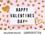 Stylish text frame lightbox with the inscription happy Valentine's day. Gold hearts all around. Foil balloons top view of Valentine's Day. Copyspace.