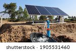 Small photo of Water pumps and solar panels. Groundwater is pumped with a submersible pump from clean energy or solar energy converted to electric energy on an agricultural farm with a copy area. Selective focus