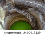Small photo of 11 26 2006 Vintage Old Helical stepwell,UNESCO worlf Heritage well with a 1.2m-wide staircase spiralling down the wall of the well shaft, Champaner, Gujarat, India,Asia.