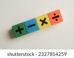 Small photo of Financial,Math,Science concept.,mathematical operation(Plus, minus, multiply, divide ) on colorful wooden cubes over white background perfect for mathematic,education,background,school idea.