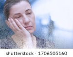 Small photo of Fibromyalgia or chronic fatigue syndrome: exhausted woman falling asleep in the office, particle dispersion effect.