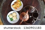 Small photo of teh poci, jadah bakar dan pisang goreng or black tea in the clay pot with misbegotten fuel and fried banana is javanese traditional food and drink