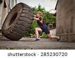 woman flipping a tire crossfit training