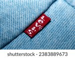 Small photo of BANGKOK, THAILAND - November 4, 2023: Close-up Levi's jeans. Levi's hat jeans' backside pocket with a red label. blue Levi Strauss jeans