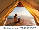 Small photo of Young woman freelancer traveler working online using laptop and enjoying the beautiful nature landscape with mountain view at sunrise