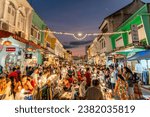 Small photo of PHUKET, THAILAND - April 24, 2023: Tourists are walking on the Phuket Walking Street is a night market that takes over the beautiful Thalang Road in Phuket Old Town every Sunday evening