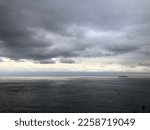 Raining sky over the sea. Cloudy sky atmosphere. Natural weather moment in rainy day.Natural gloomy sky weather background. Dramatic storm cloudy and dark sky. 