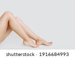 young slender legs of a woman on a white background copy the space. the concept of depilation of the skin