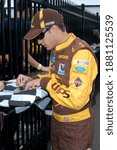 Small photo of Long Pond, PA, USA - June 11, 2011: NASCAR driver David Ragan signs autographs before the start of qualifying for the 2011 5-Hour Energy 500 at Pocono Raceway in Pennsylvania.