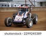 Small photo of Indianapolis, IN, USA - May 23, 2019: Race driver Jason McDougal slides his USAC Silver Crown race car through a turn on the Indiana State Fairgrounds mile. Car is slightly blurred to show speed.