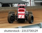 Small photo of Indianapolis, IN, USA - May 27, 2011: A young Kyle Larson slides his USAC Silver Crown car through a turn on the Indiana State Fairgrounds mile. Car slightly blurred to show speed and action.