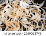 Small photo of Close Up View of Sliced Onions Browned in a Skillet: Slices of sweet onion cooked in olive oil browning in a frypan