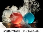 Small photo of Magic and wizardry concept. Set of sorcery book, magic potions and candles on table. Health and mana potion. Alchemy concept.