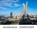 Small photo of Aerial view of Sao Paulo city skyline, marginal Pinheiros avenue, modern Cable stayed bridge, Pinheiros River and corporate buildings in sunny summer day. Brazil, South America.