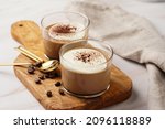Italian chocolate and coffee mousse dessert semifreddo - half-frozen ice cream with whipped cream and cocoa powder in small glasses